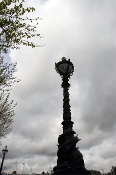 iconic victorian embankment lamposts against a stormy background