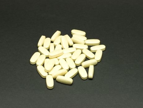 Pile of pills on black