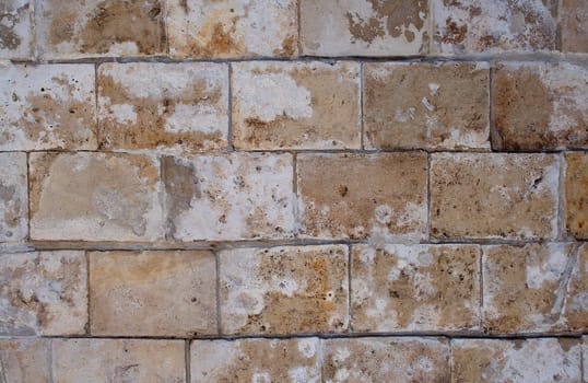 A pattern of white rectangular natural stone textured blocks.