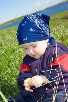 boy on meadow with dandelion.small child