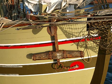 Traditional beautiful old wooden sail boat with metal anchor