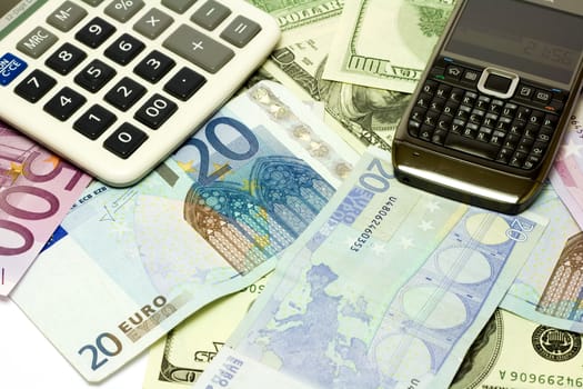 Dollar, euro banknotes, calculator, cellphone