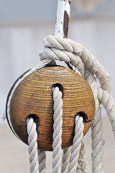 Close-up of a vintage sailboat: wooden tool and ropes