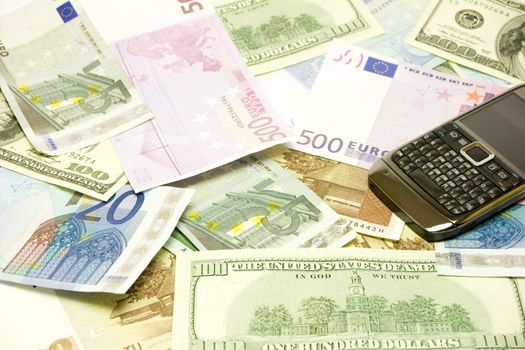Dollar, euro, latvian lat banknotes and cellphone