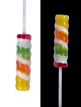 Two lollipop sticks pointing in opposite directions over black and white backgrounds respectively