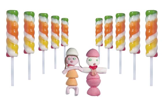 A couple of candy people in the middle of several lollipop sticks in a perspective disposition over white background.