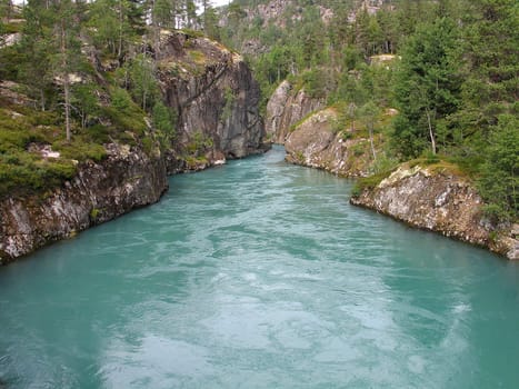 River with typical color of melted snow water in the fjords area Sognefjord 