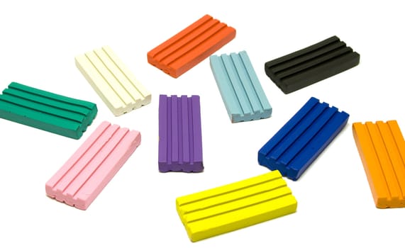Colorful plasticine bricks on white