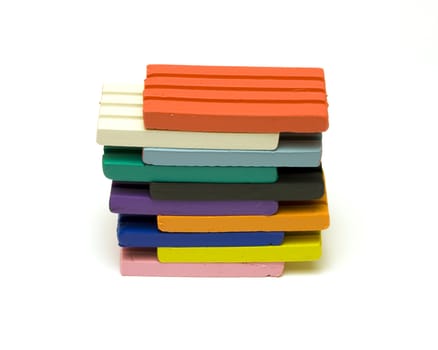 Colorful plasticine bricks on white