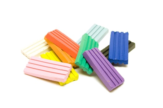 Colorful plasticine bricks on white