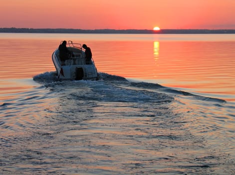 Speedboat sails into the sunset