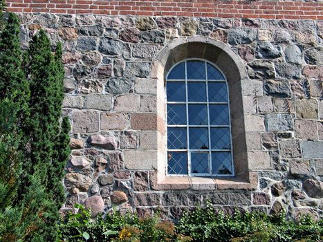 Window of an old church in the country in Denmark