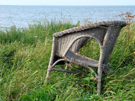 Old abandoned chair on the beach