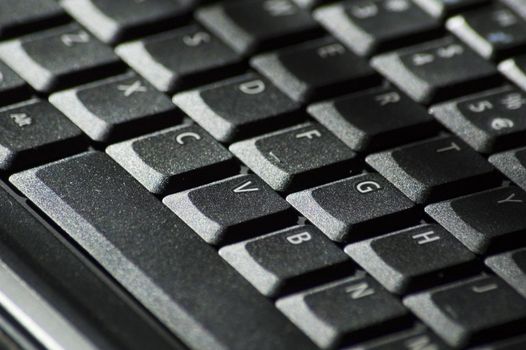 black computer keyboard showing a few letters in closup