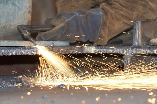 a shipyard steel worker burning steel