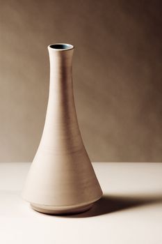 brown ceramic vase on a white table