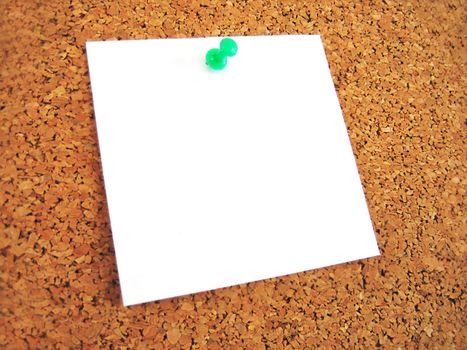 white blank note pined to cork board
