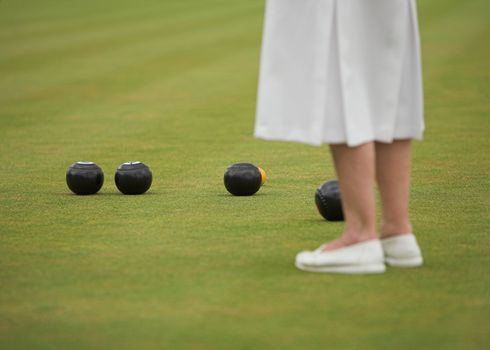 Female player in a game of lawn bowls.