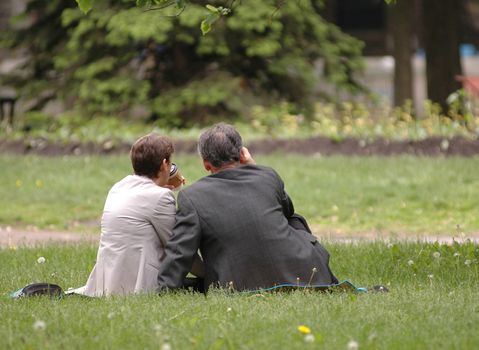 Couple of workers having lunch in a city park