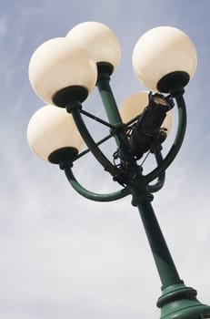 Close up view of a city lamp with a blue sky