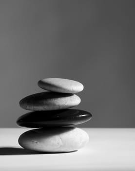 a stack of four diffent rocks on a table