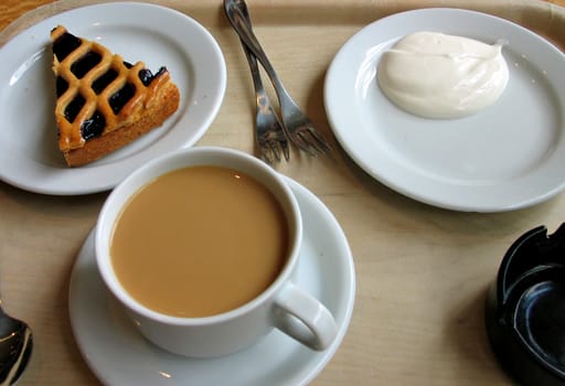 Coffe, cake and cream served in a coffee shop