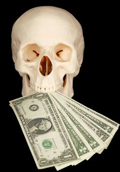 Horrible skull with a bundle of money in his mouth on a black background