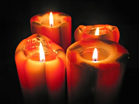 Big  and colorful decorative candles glow in the dark