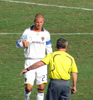 LA Galaxy soccer player and captain David Beckham. Beckham holds and soccer ball as he walks toward the referee in a game against the FC Dallas Hoops on Sunday, July 27,  2008 in Frisco, Texas.
