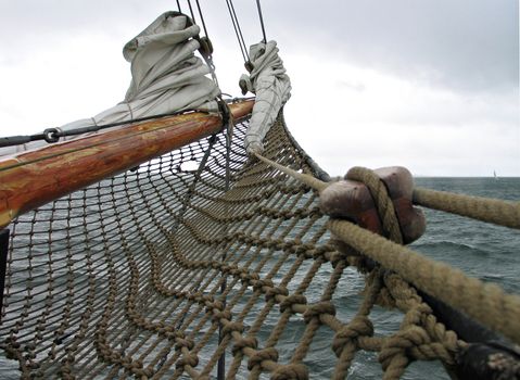 Traditional old wood sailboat sails in the winter