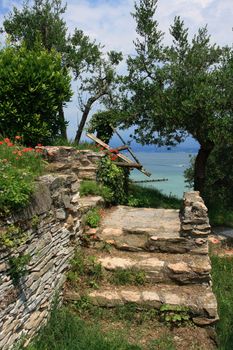 Steps with red poppies and lake in the distance