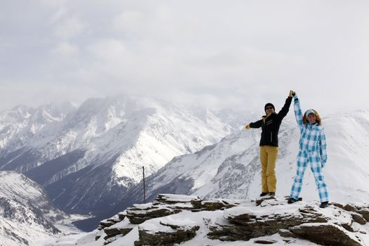 Two girls on a hill of mountain Elbrus