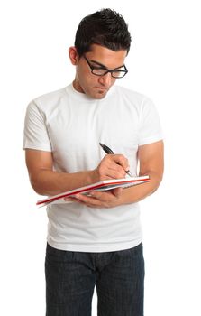 A man writes in a spiral notebook lecture pad