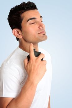 A male spraying perfume cologne fragrance to his neck area.