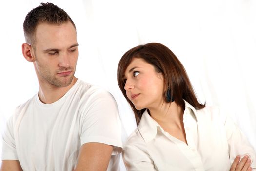 Young couple fights. Both people stand back to back and look sad