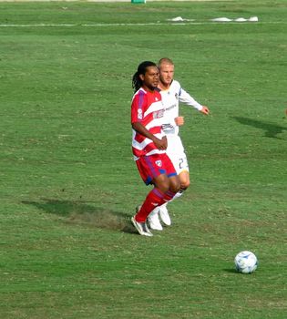 David Beckham and Adrian Serioux go for the ball during a soccer game between the LA Galaxy and FC Dallas on July 27, 2008 in Frisco, Texas.
