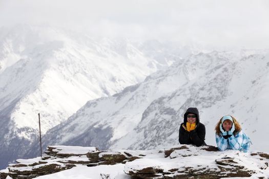 Two girls on a hill of mountain Elbrus