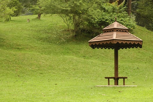 A wooden umbrella hut at park