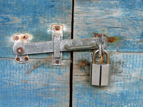 Door made with blue wooden panels with a lock