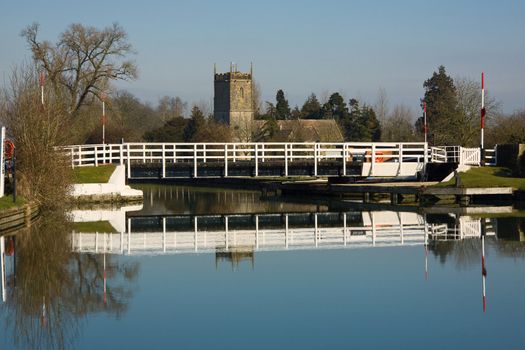 Winter sunlight at Splatt Bridge on the Gloucester and Sharpness canal, with Frampton upon Severn church in the background