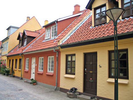 Old street and houses in the old city area Odense Denmark