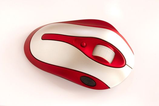 red and silver wireless computer mouse over a light background