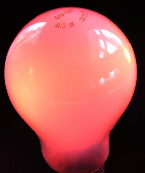 red bulb over a black background