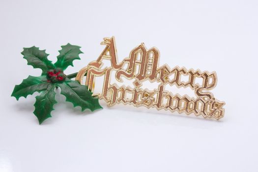 merry christmas sign with a holly leaf