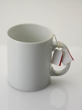 mug with tea bag on the plain background