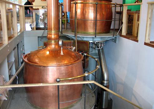 Old style brewery brew house inside a restaurant with traditional copper tanks 