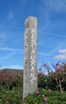 Sign of a restaurant on a wooden Totem pole