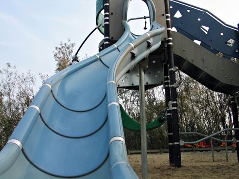 Modern design slide made from wood and plastic in a playground