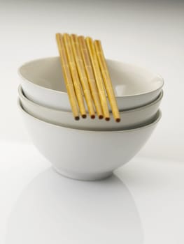 chockstick rest on the bowls on the plain background