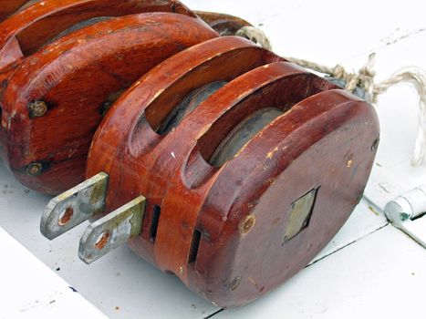 Pulley for sails and ropes made from wood on an old sail boat